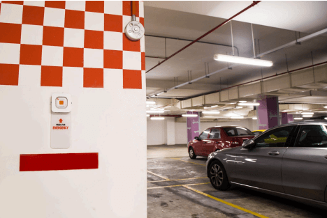 Close-up of an emergency alarm/panic button in a parking garage, for security assistance