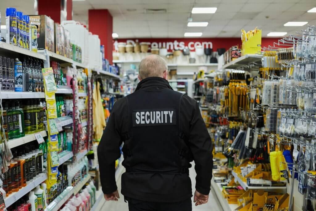 On-site grocery store security guard monitoring a Denver retail entrance